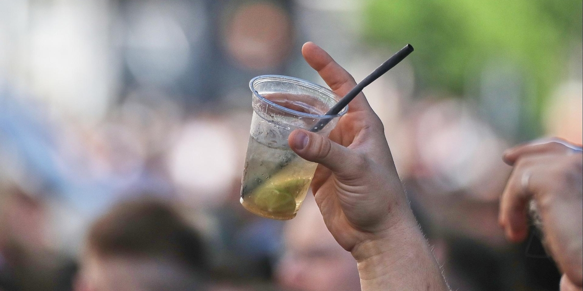 Ein Mann hält ein alkoholisches Getränk hoch (Archiv)