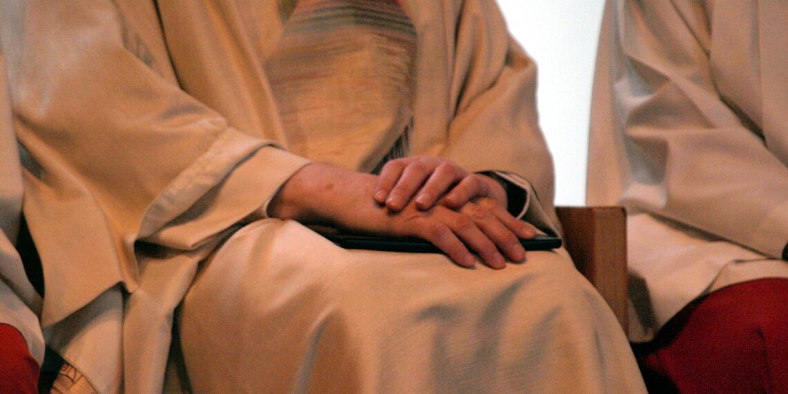 Katholischer Pfarrer bei einer Messe zwischen Ministranten (Archiv)